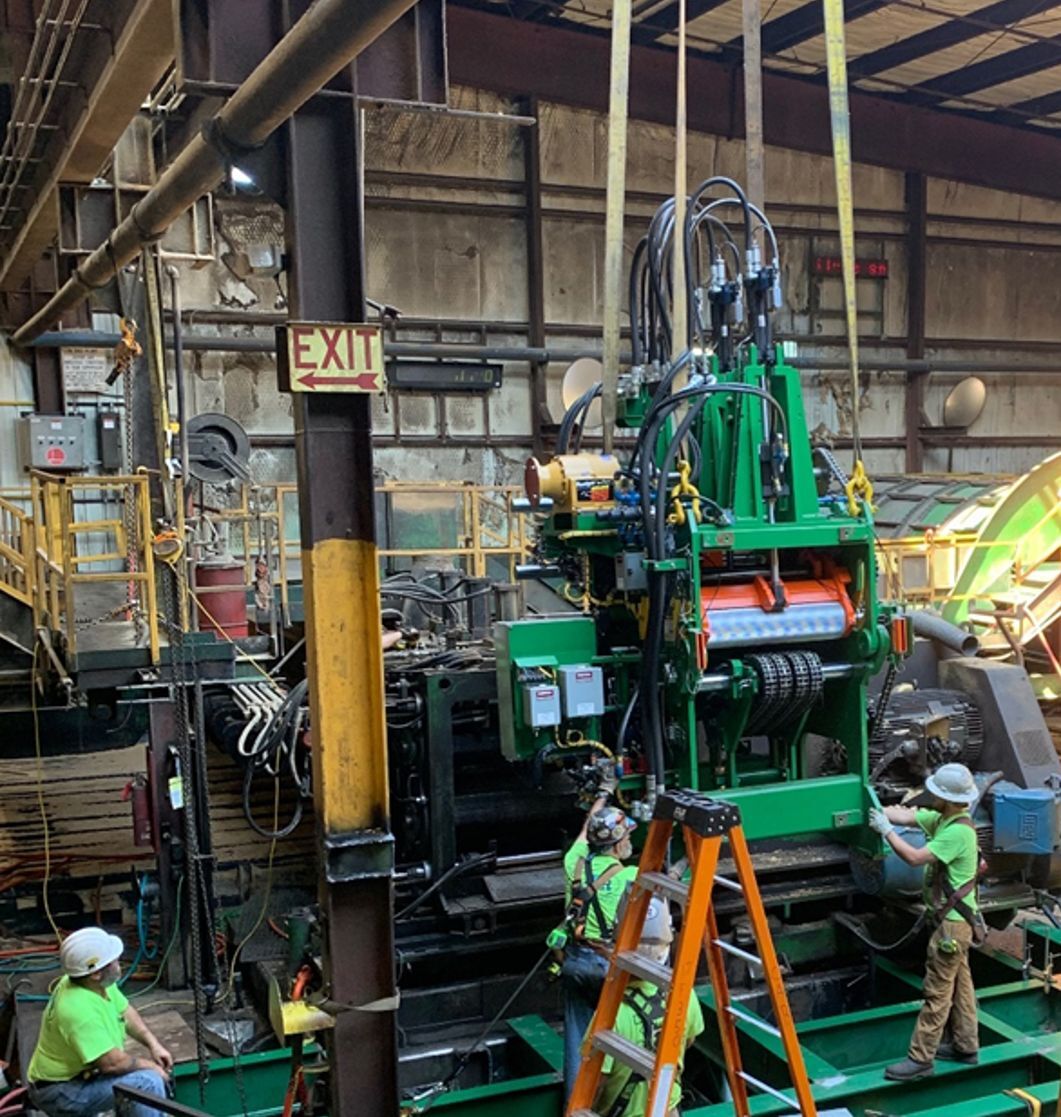 D.R. Reynolds construction workers installing heavy machinery.