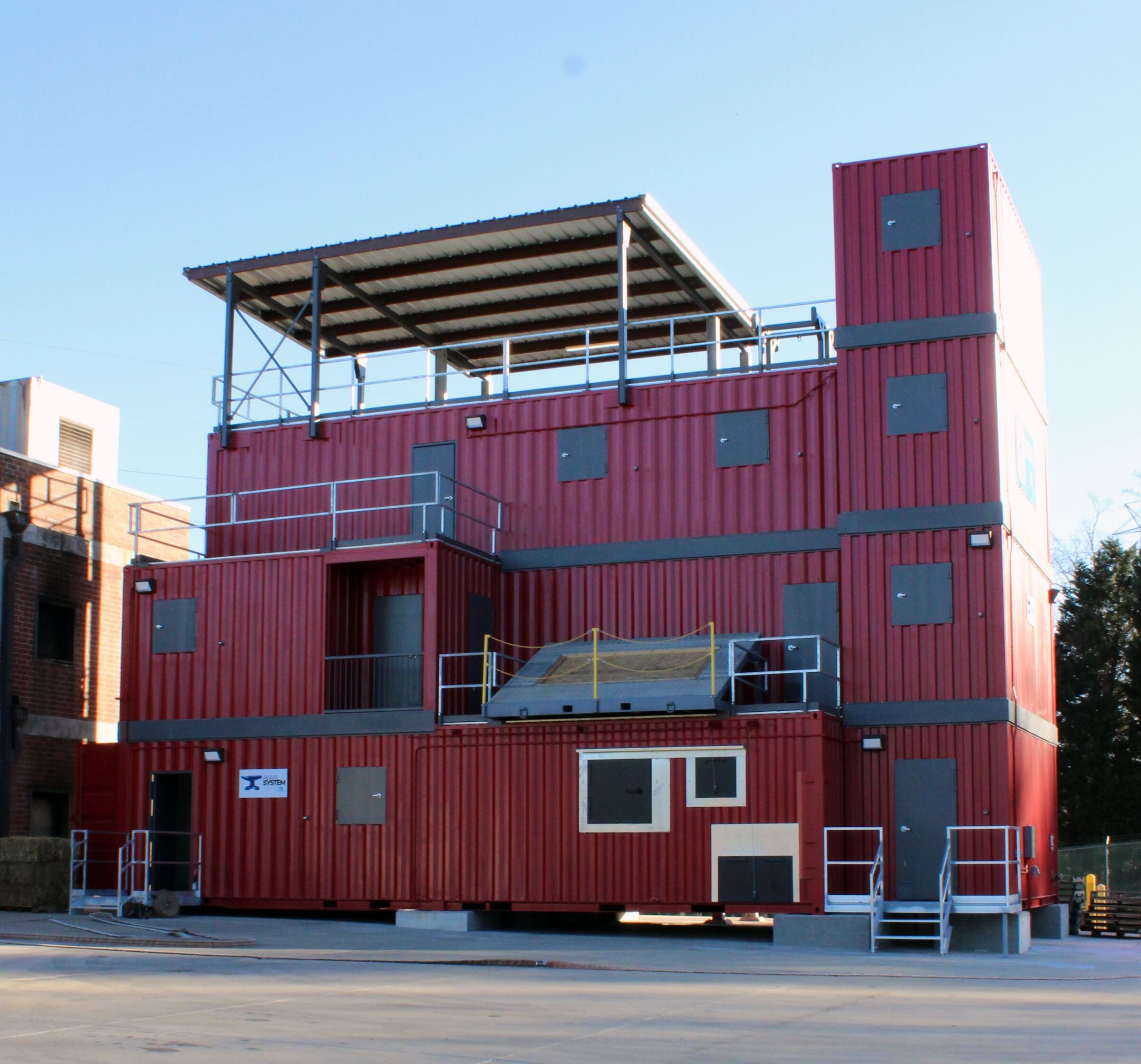 Multi-story Anvil live burn fire training structure at Guilford Technical Community College with training platforms, stairs, and rooftop access.