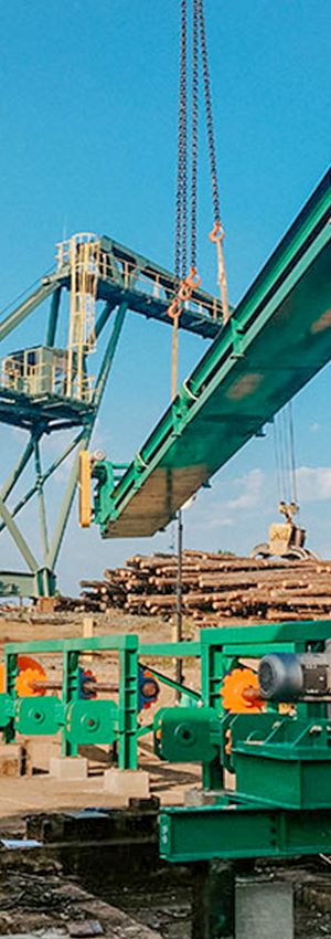 Crane Lowering industrial steel equipment into place on jobsite